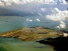 Aerial view of an island airport surrounded by the sea.