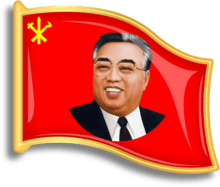 Red, flag-shaped pin with a smiling Kim jong-il
