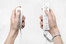 Two types of Wii controllers, one in each hand