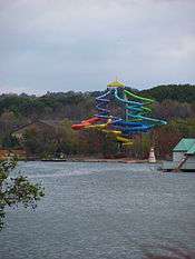 Multicolored water slide in wooded setting