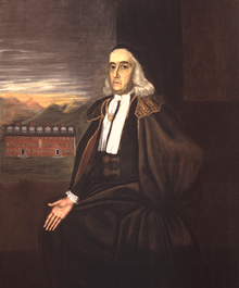 A full length seated portrait of the elderly William Stoughton. Harvard College's Stoughton Hall is visible in the background.