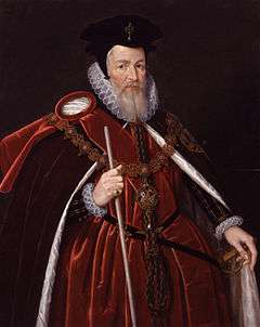 A full-color portrait of William Cecil.  Ceclil is wearing orange robes and a large black hat.  He is facing toward the camera's right, holding a white cane in his right hand and holding his cape open with his left.