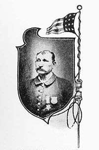 Portrait of a white man with a mustache and thinning hair, wearing a jacket with two medals pinned to the left breast. The portrait is in a shield-shaped frame next to a sketch of an American flag.