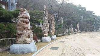 Cave rocks align the rock landscape next to the sports field in Wolmyeongdong