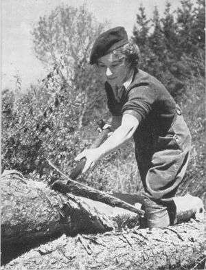 A black-and-white photograph of a uniformed woman at work