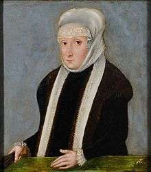 A woman in black wearing a long white scarf on her head and around her neck