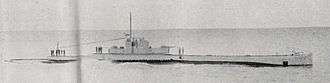 a black and white photograph of a submarine underway on the surface
